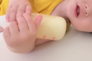 哺乳瓶を持つ赤ちゃん