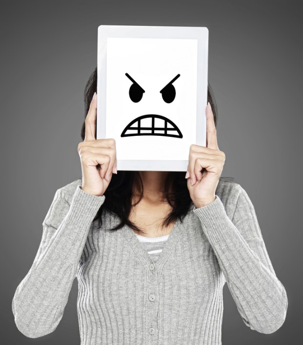 怒った顔のイラストを持つ女性